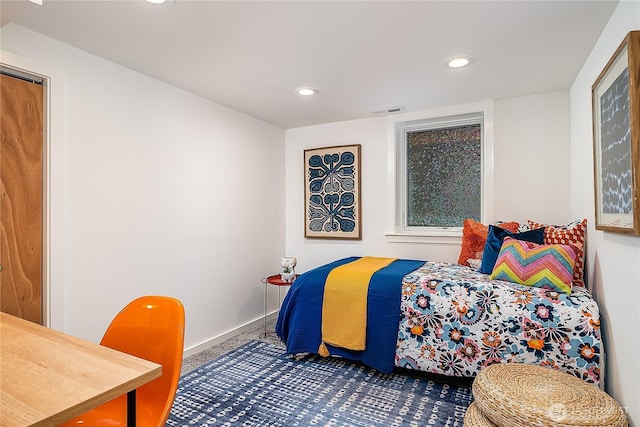 carpeted bedroom featuring recessed lighting, visible vents, and baseboards