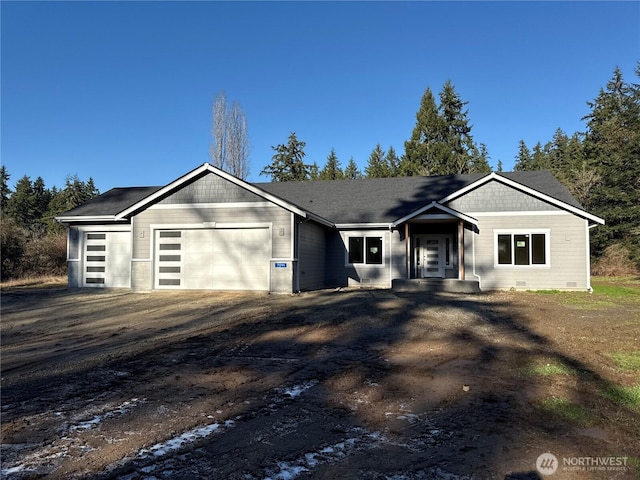 view of front of house featuring driveway, crawl space, and an attached garage