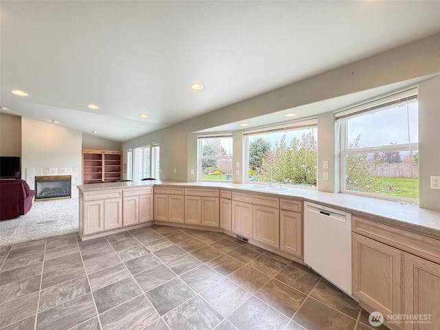 602 Mccomb Rd, Sequim, WA 98382 - kitchen with a glass covered fireplace, light countertops, lofted ceiling, white dishwasher, and a sink