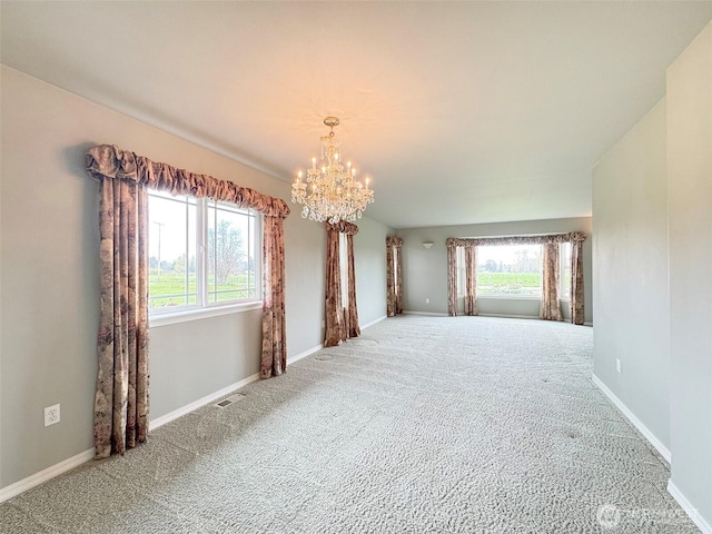 602 Mccomb Rd, Sequim, WA 98382 - spare room featuring a notable chandelier, carpet flooring, visible vents, and baseboards
