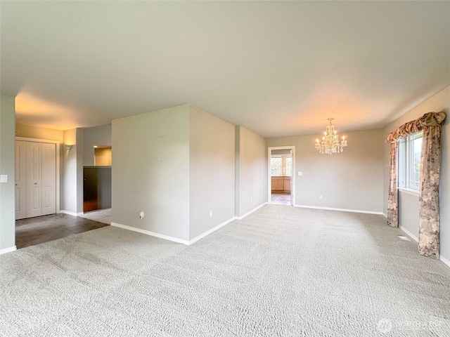 602 Mccomb Rd, Sequim, WA 98382 - carpeted spare room with a chandelier, baseboards, and a healthy amount of sunlight