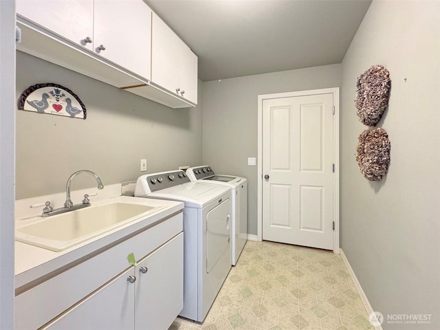 602 Mccomb Rd, Sequim, WA 98382 - washroom with light floors, independent washer and dryer, a sink, baseboards, and cabinet space