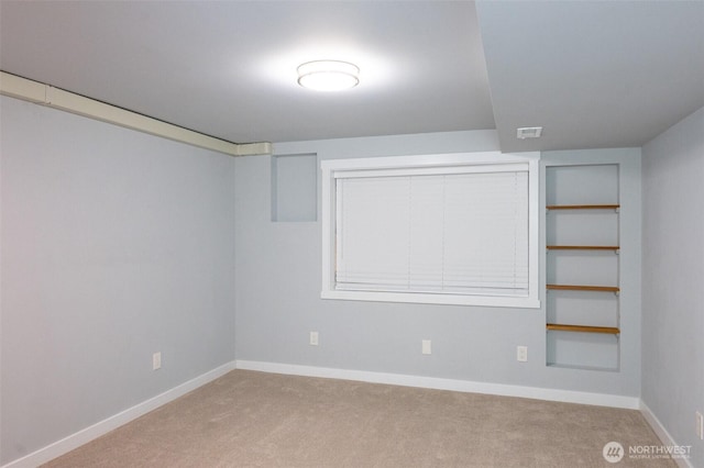 carpeted empty room with baseboards