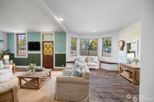 living room with baseboards, wood finished floors, and recessed lighting