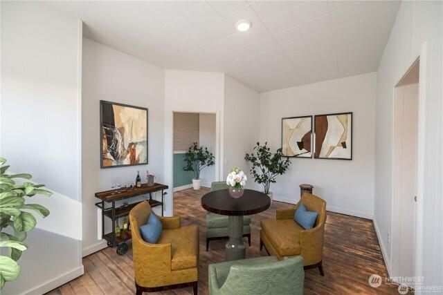 living area featuring baseboards and wood finished floors