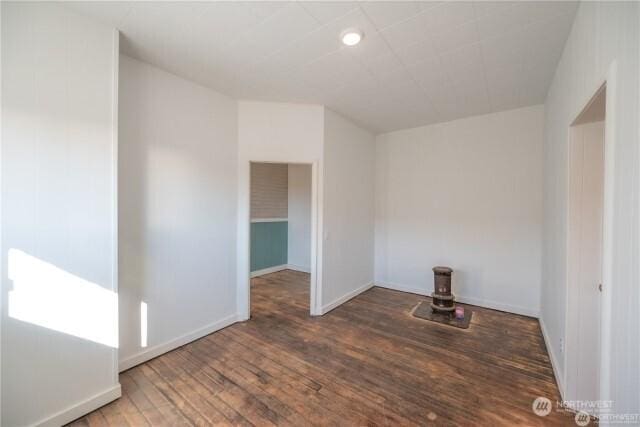 empty room featuring baseboards and wood finished floors