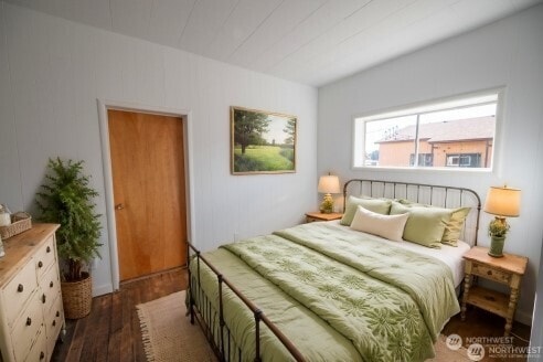 bedroom with dark wood finished floors