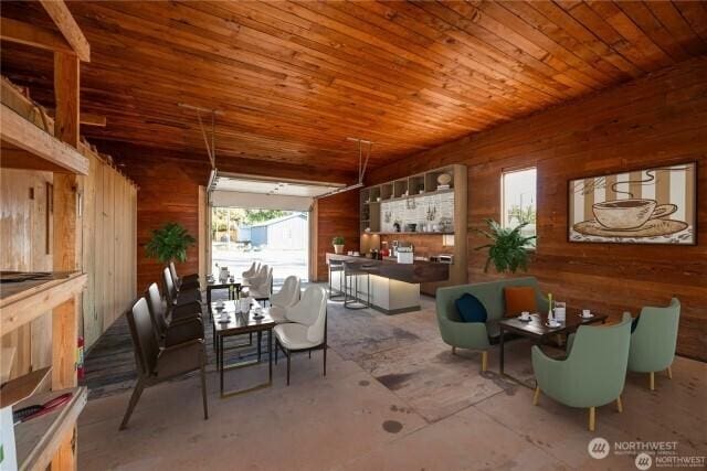 dining room with wood walls and wood ceiling