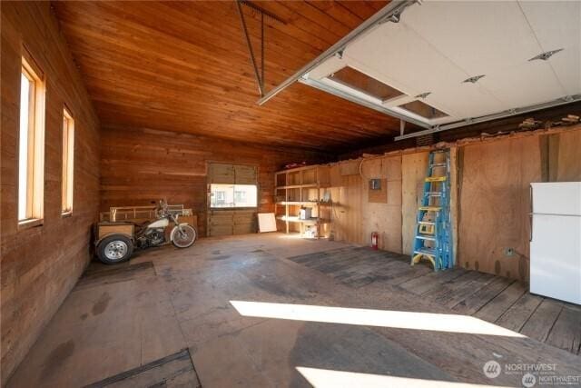 garage with wooden ceiling and freestanding refrigerator