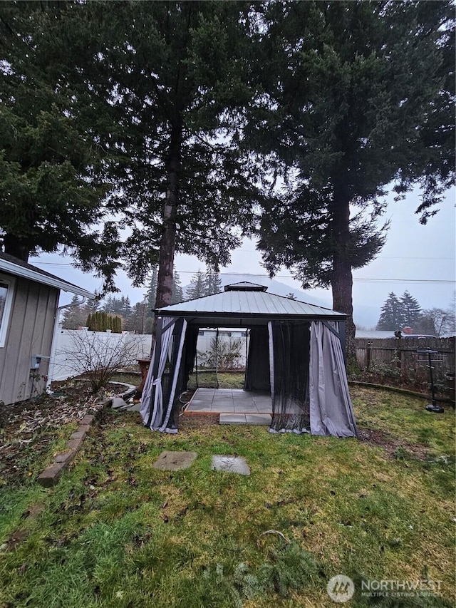 exterior space featuring fence and a gazebo