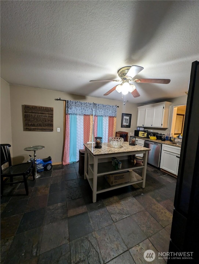 kitchen with a center island, open shelves, stainless steel dishwasher, stone finish flooring, and white cabinets