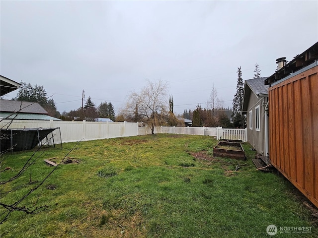 view of yard with a fenced backyard and a vegetable garden