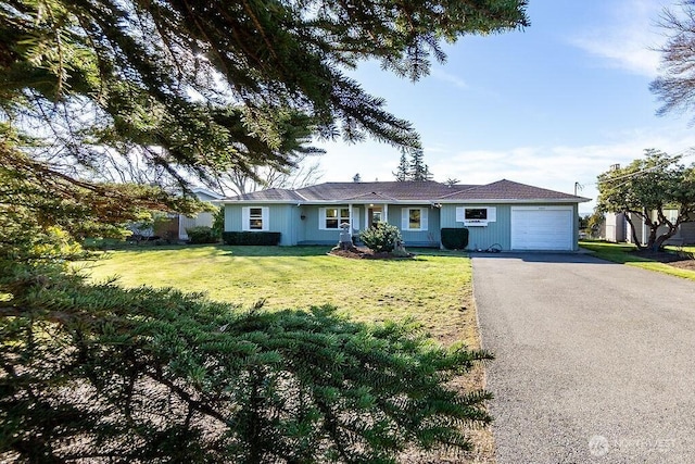 ranch-style home with driveway, a front lawn, and an attached garage