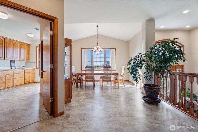 dining area with recessed lighting, baseboards, lofted ceiling, and an inviting chandelier