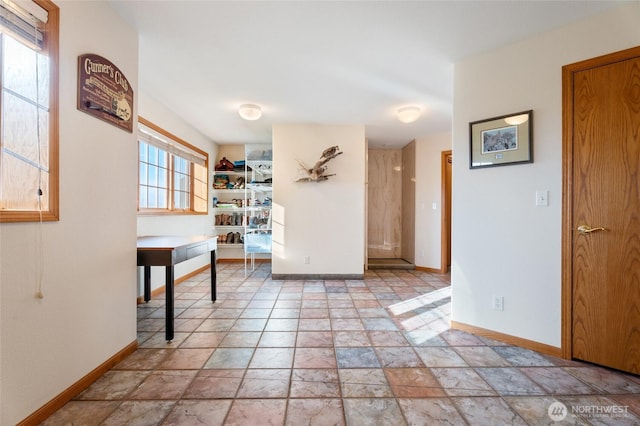 interior space featuring stone tile floors and baseboards