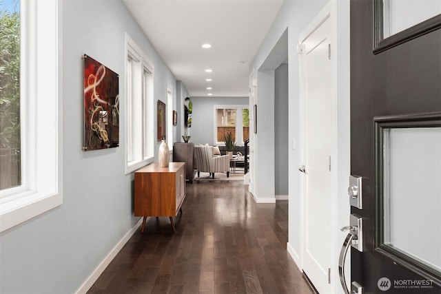 hall featuring recessed lighting, dark wood finished floors, and baseboards