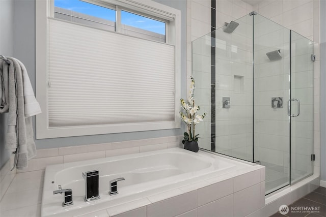 full bathroom featuring a stall shower and a bath