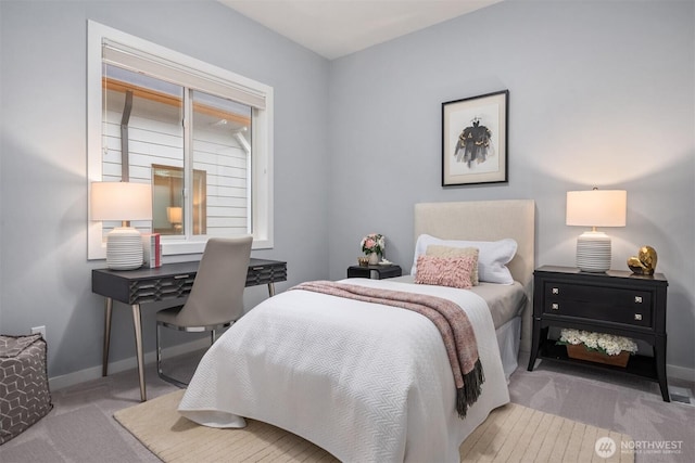 carpeted bedroom featuring baseboards