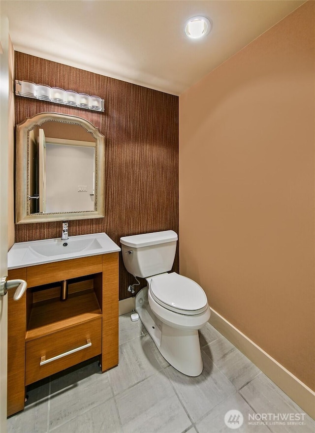 2821 2nd Ave Unit 1005, Seattle, WA 98121 - half bath with tile patterned floors, vanity, baseboards, and toilet