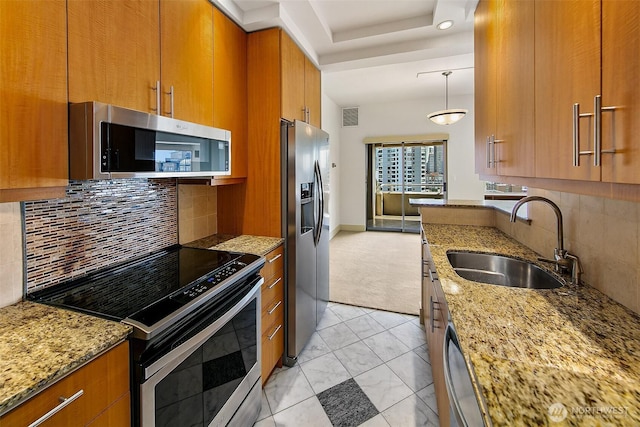 2821 2nd Ave Unit 1005, Seattle, WA 98121 - kitchen with visible vents, a sink, brown cabinets, light stone countertops, and stainless steel appliances