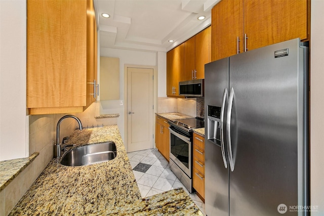 2821 2nd Ave Unit 1005, Seattle, WA 98121 - kitchen with light stone countertops, recessed lighting, appliances with stainless steel finishes, a sink, and backsplash