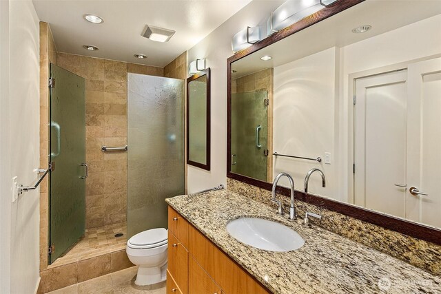 2821 2nd Ave Unit 1005, Seattle, WA 98121 - full bathroom with a shower stall, vanity, tile patterned flooring, recessed lighting, and toilet