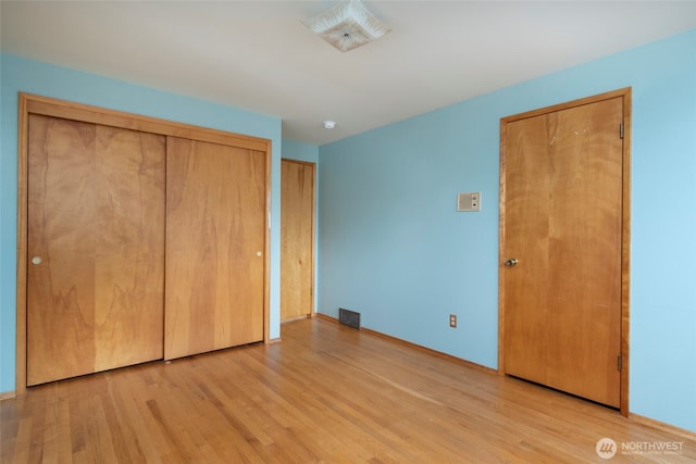 unfurnished bedroom with light wood finished floors