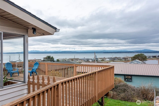 wooden terrace with a water and mountain view