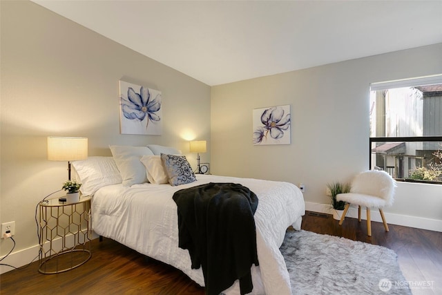 bedroom featuring wood finished floors and baseboards