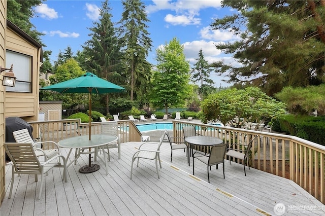 wooden deck featuring a fenced in pool