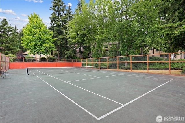 view of tennis court with fence