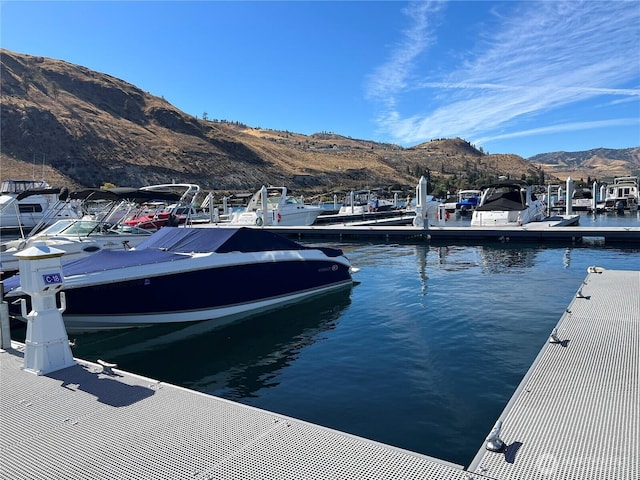 view of dock featuring a water and mountain view