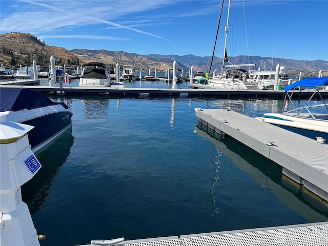 view of dock featuring a water and mountain view