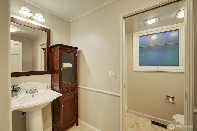 bathroom featuring visible vents, baseboards, toilet, ornamental molding, and tile patterned flooring