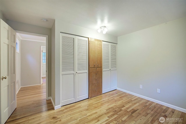 unfurnished bedroom with light wood-style floors and baseboards