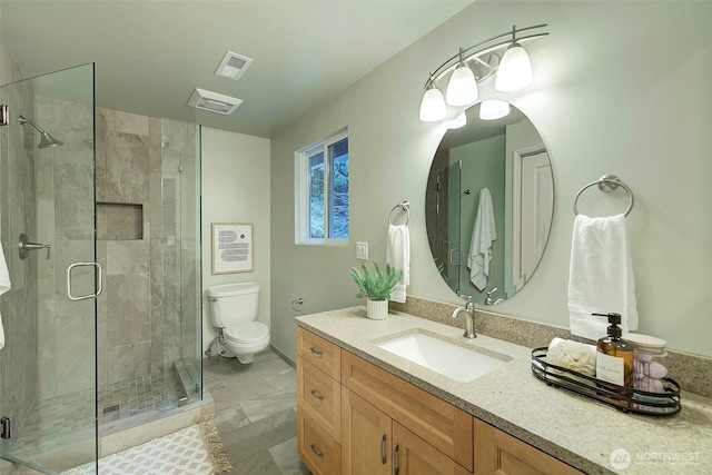 bathroom with toilet, a shower stall, and visible vents