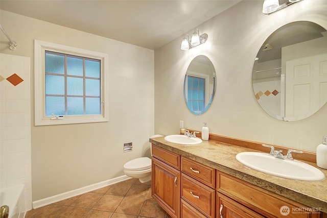 full bathroom featuring tile patterned flooring, a sink, toilet, and double vanity