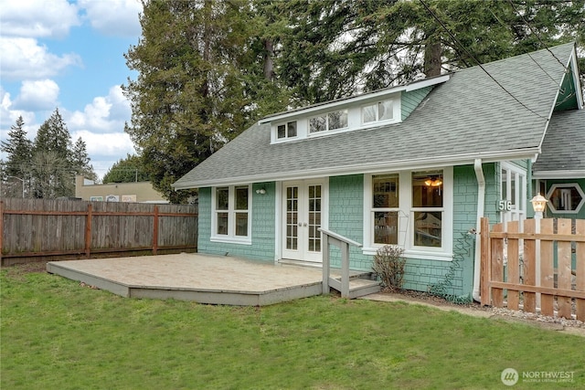 back of house with french doors, a lawn, fence private yard, and a shingled roof