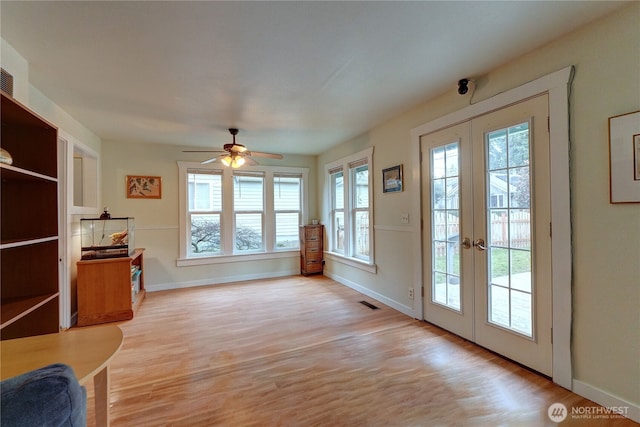 doorway to outside with light wood-type flooring, french doors, baseboards, and a healthy amount of sunlight