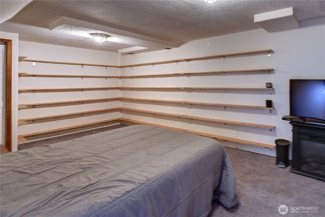 bedroom featuring a textured ceiling and carpet floors