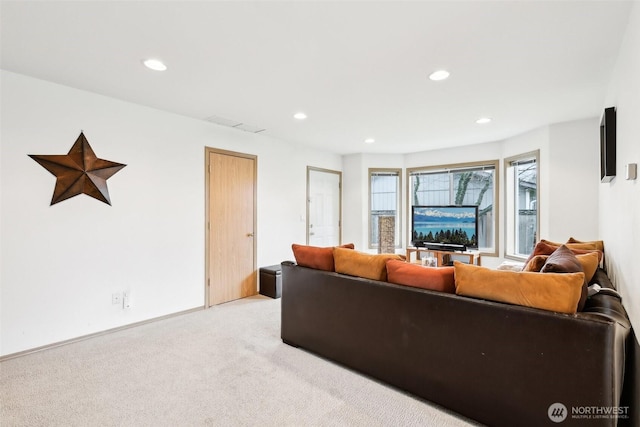 living room featuring recessed lighting and light carpet