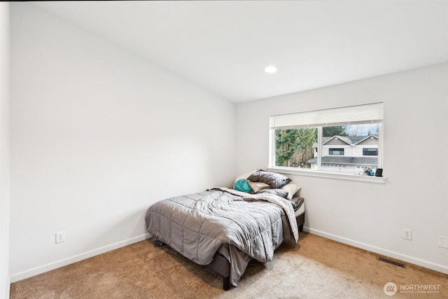 carpeted bedroom featuring visible vents and baseboards