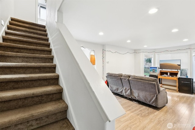 staircase featuring recessed lighting and wood finished floors