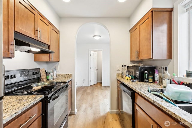 kitchen featuring range with electric cooktop, arched walkways, dishwashing machine, light wood-type flooring, and under cabinet range hood