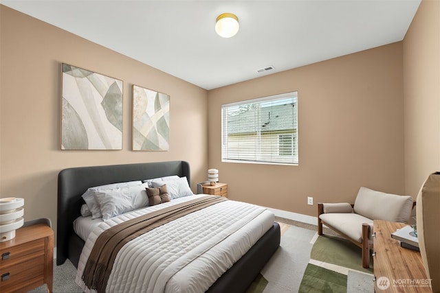 bedroom featuring carpet floors, visible vents, and baseboards