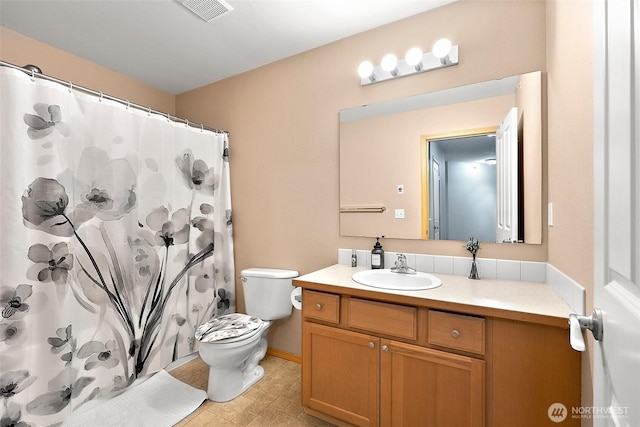 bathroom with toilet, curtained shower, visible vents, and vanity