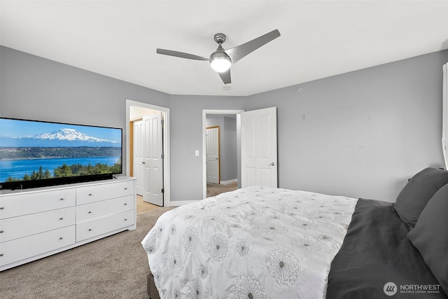 bedroom with light colored carpet, ceiling fan, and baseboards