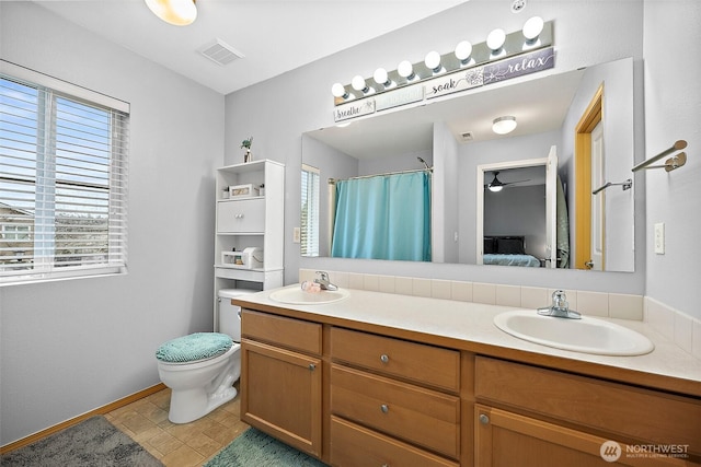 full bath featuring a sink, visible vents, and a healthy amount of sunlight