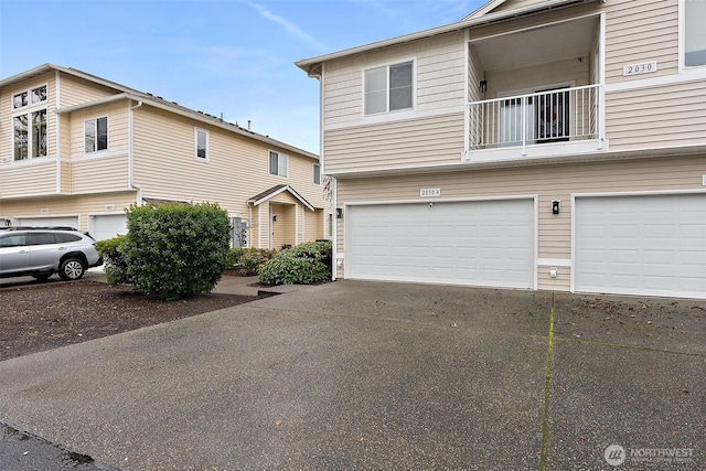 multi unit property featuring a balcony and a garage