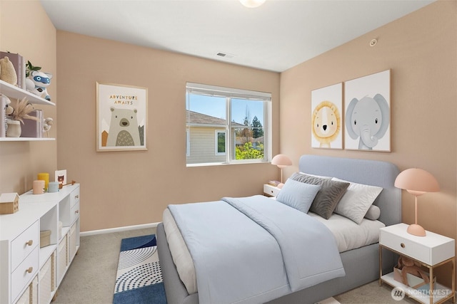 bedroom with baseboards, visible vents, and light colored carpet